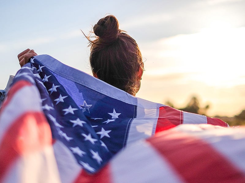 american flag held by a woman